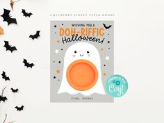 a halloween greeting card with a ghost holding an orange frisbee in front of bats