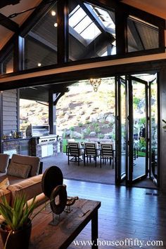 an open living room and dining area with sliding glass doors