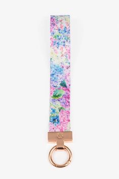 a keychain with a pink, blue and green tie dye pattern on it