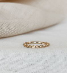 a gold ring sitting on top of a white cloth