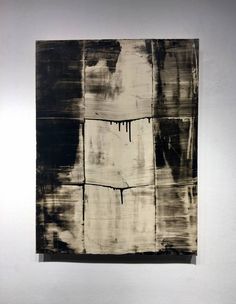 an abstract painting hanging on the wall next to a white and black piece of artwork