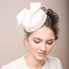 For the modern bride seeking timeless elegance, the Bridal Fur Felt Pillbox offers versatile sophistication. Adorned with an artful swirl trimming and a delicate birdcage veil.  Wear it perched gracefully atop your head, tilted to the side for a touch of flair, or even positioned elegantly over an intricate updo. The hat will add a height and balances your face nicely. The bridal pillbox is handcrafted from luxurious fur felt, showcasing a velvety velour finish, contributing to the hat's overall Double Headband, Bridal Fur, Veiled Hats, Feather Headpiece, Bridal Fascinator, Wedding Veil Accessories, Bride Hat, Bridal Hat, Birdcages