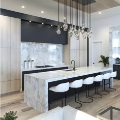 a modern kitchen with marble counter tops and white stools in front of an island