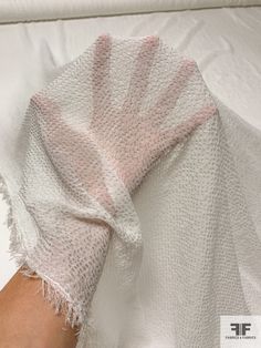 a person's arm wrapped in a white blanket