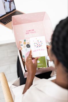 a woman is holding up a box with an open lid and the inside of it