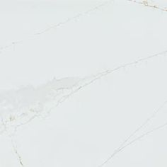 a white marble counter top with gold veining on it's edges and an abstract design