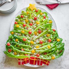 a christmas tree made out of lettuce on a plate