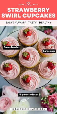 strawberry swirl cupcakes on a white plate with pink frosting and strawberries