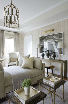 a living room filled with furniture and a chandelier