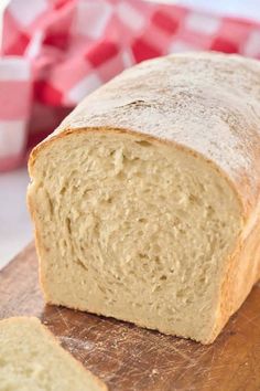 a loaf of bread sitting on top of a wooden cutting board