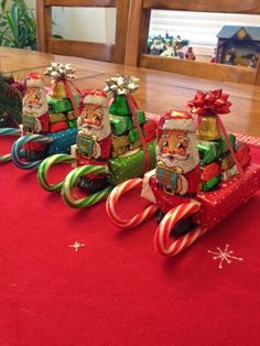 a group of santa clause riding on top of a sleigh with candy canes