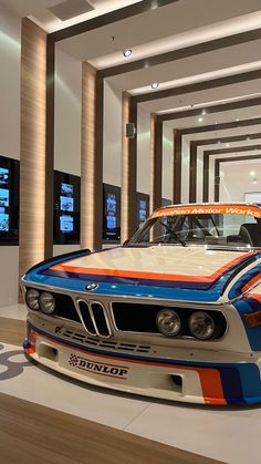 two bmw cars are on display in a showroom