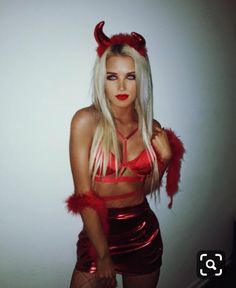 a woman dressed in devil costume posing for the camera