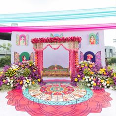 a decorated stage with flowers on the floor