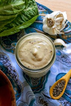 a glass jar filled with food sitting on top of a blue and white table cloth