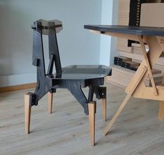 two wooden chairs sitting next to each other on top of a hard wood floor