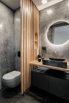 a bathroom with a toilet, sink and mirror