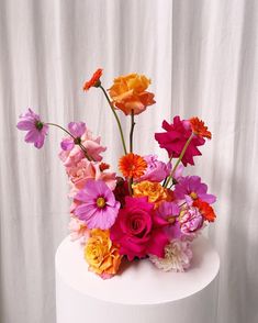 a white cake with colorful flowers on top