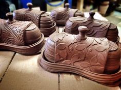 some brown pottery sitting on top of a wooden table