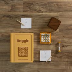 a wooden table topped with lots of different types of writing and office supplies on top of it