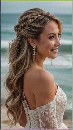 a woman with long hair wearing a white dress on the beach, smiling at the camera