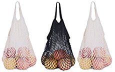 three mesh bags with fruit in them on a white background