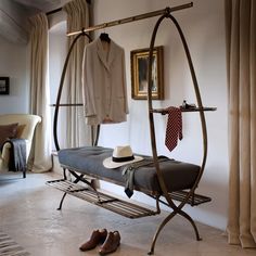 a room with a bed, coat rack and shoes