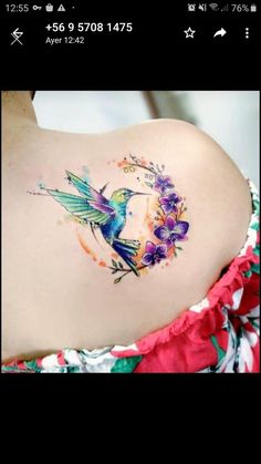 the back of a woman's stomach with a hummingbird and flowers on it