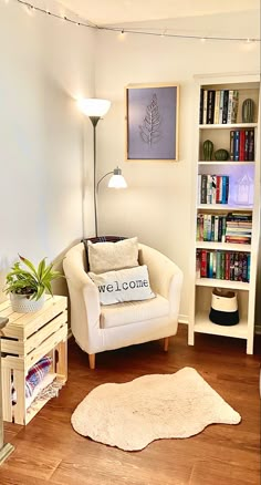 a living room filled with furniture and bookshelves next to a lamp on a wooden floor