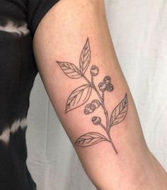 a black and white flower tattoo on the arm