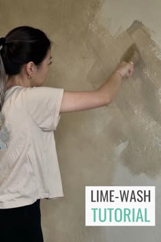 a woman painting a wall with a paintbrush in her hand and the words time - wash on it