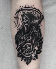 a black and white tattoo on the leg of a man with a rose in front of him