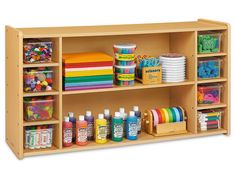 a wooden shelf filled with lots of craft supplies