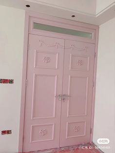 two pink doors in a room with white walls