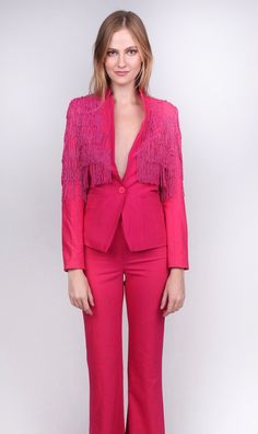 Who wants to simply feel "pretty in pink" when you can be looking perfect in it! The Any Old Iron Pink Fringe Suit elevates a pink ensemble from being cute to being drop dead gorgeous by utilizing a feminine silhouette and subtle details that are sure to blow the crowd away. This hot pink blazer and fit and flare trouser combo makes a statement with its rich utilization of color and through the fringe that cascades down the shoulders. This fringe consists of hand-assembled, beaded strands, which Hot Pink Blazer, Hot Pink Blazers, Drop Dead, Feminine Silhouette, Pink Blazer, Flare Trousers, Feel Pretty, Suit Accessories, Bubblegum Pink