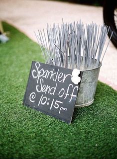 a sign that says sparkler and off on it next to some sticks in a bucket