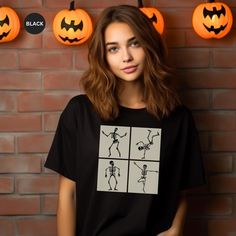 Celebrate Halloween with this funny dancing skeletons T-Shirt design.  Makes a great gift. This classic unisex jersey short sleeve tee fits like a well-loved favorite. Soft cotton and quality print make users fall in love with it over and over again. These t-shirts have-ribbed knit collars to bolster shaping. The shoulders are tapered for a better fit over time. Dual side seams hold the garment's shape for longer. .: Made with 100% Airlume combed and ring-spun cotton, a lightweight fabric (4.2 o Funny Dancing, Skeleton T Shirt, Dancing Skeletons, Funny Skeleton, Skeleton Shirt, Dance Humor, Halloween Skeleton, Prism Color, Halloween Gift