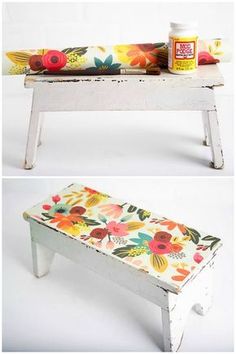 an old bench with flowers painted on it and some paint sitting on top of it