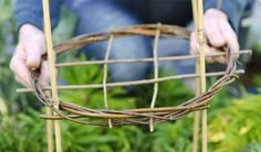 a person holding a wire basket in their hands