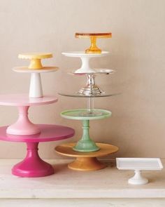 three tiered trays with different colored dishes on them