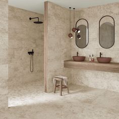 a bathroom with two sinks and mirrors on the wall, along with a wooden stool