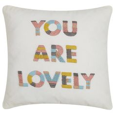 a white pillow with the words you are lovely embroidered on it