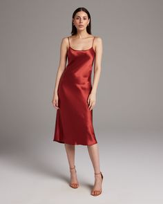 Bias cut Midi Slip Dress elegantly drapes on the body. This perfect basic can be worn for life, dressed up, or dressed down, for the perfect ensemble. Style with a sweater and boots in the Fall or wear with sandals in the Summer. 100% Silk Charmeuse Made in New York City Product Care: Dry Clean Only Dress Elegantly, Minimalist Outfits, Warm Dresses, Poncho Tops, Convertible Dress, Midi Slip Dress, Silk Tank, Silk Charmeuse, Wrap Blouse