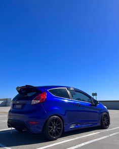 a blue car parked in a parking lot