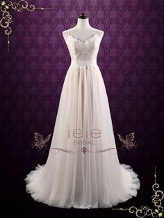 a wedding dress on display in front of a purple wall