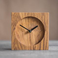 a wooden clock sitting on top of a table