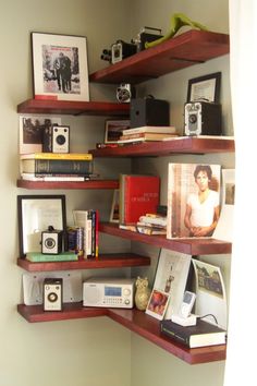 the shelves are filled with books, pictures and other items