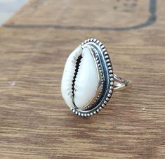 Cowrie Ring, Sterling Silver Shell Ring, Natural Shell Ring, Cowry Kauri Shell, Ibiza Ring, cowrie Silver Ring, Boho Yoga Ring, Gift for mom It brings good luck, wealth, prosperity, fame and the power of destiny. Cowry shells are used in some religious or auspicious ceremonies too, like in Laxmi puja cowrie shells are kept to please Goddess Laxmi and be blessed by Her and Lord Vishnu. Bohemian Oval Jewelry For The Beach, Bohemian Oval Jewelry For Beach, Handmade White Shell Rings, White Shell-shaped Rings For Beach, White Beach Ring Jewelry, Bohemian Beach Toe Rings, White Shell Rings For The Beach, White Shell Rings For Beach, White Toe Ring For Beach