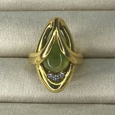 Vintage Grosse Germany 1973 | 14k Gold Ring | Jade Stone With Diamonds | Size 3.5 | Formal Yellow Gold Diamond Ring With Gemstone, Elegant Marquise Yellow Gold Emerald Ring, Yellow Gold Marquise Emerald Ring, Collectible Multi-stone Yellow Gold Diamond Ring, Collectible Yellow Gold Emerald Cabochon Ring, Collectible Yellow Gold Emerald Ring With Cabochon, Yellow Gold Cabochon Ring In Fine Jewelry Style, Fine Jewelry Yellow Gold Cabochon Rings, Fine Jewelry Yellow Gold Emerald Ring For Collectors