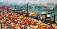 a harbor filled with lots of containers and large ships next to each other in the water